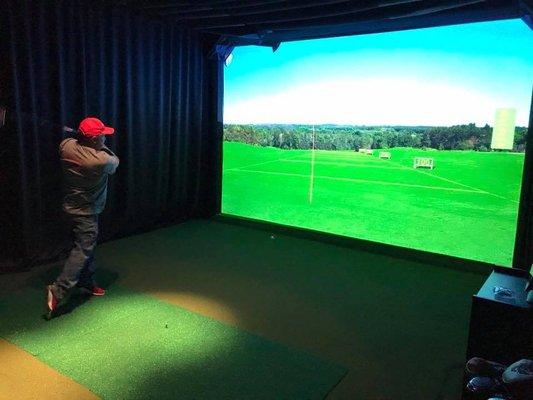 Driving range practice on the HD Golf Simulator.