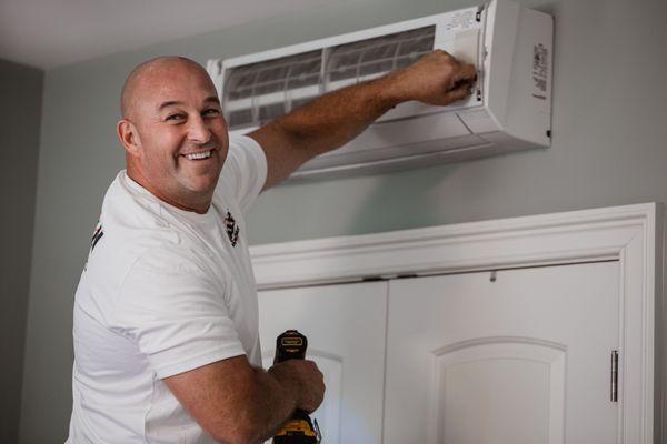 Jay inspecting a heat pump.