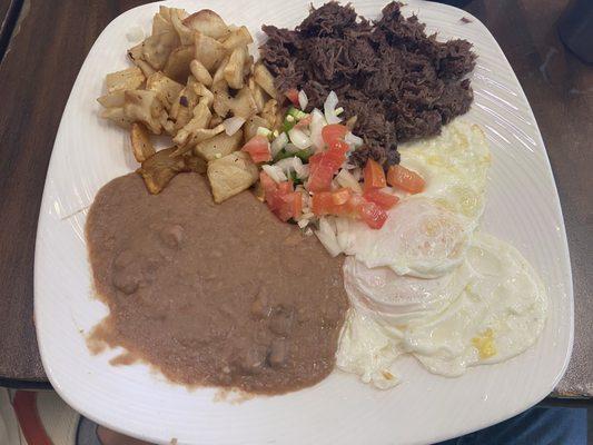 Barbacoa plate with eggs, potatoes and beans