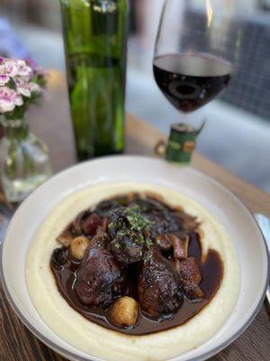 Coq au vin - red wine braised chicken legs.