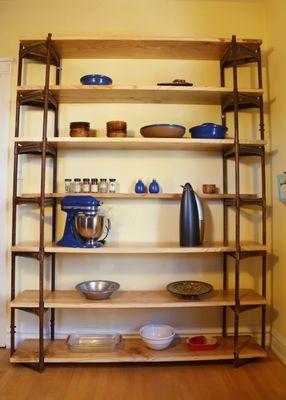 Custom shelving unit made from reclaimed antenna tower and Ash.