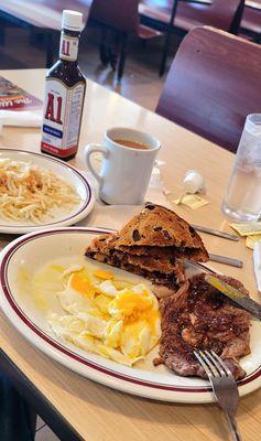 3/29/24 Ribeye steak and eggs medium Eggs sunny-side up Hash browns raisin toast cawfee