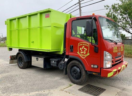 Junk Rescue truck with a new lime green 15 yard dumpster.