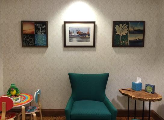 Our waiting room with photography and artwork by our staff.