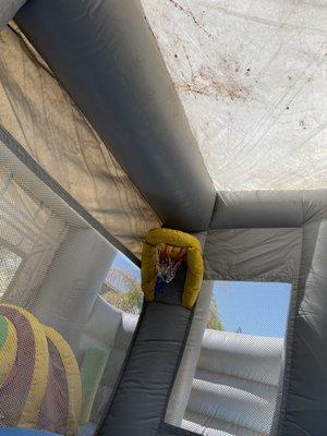 Inside and top of bounce house full of dirt and filthy.