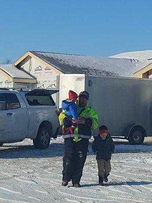 Josh hard at work. Takes a minute to show his boys the job site.