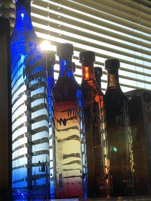 The sunlight shines through in the early evening, making the colorful tequila bottles look amazing!