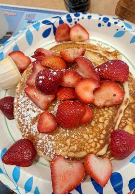 Pancake stack with butter (added on strawberries and whipped cream is optional) - syrup not pictured