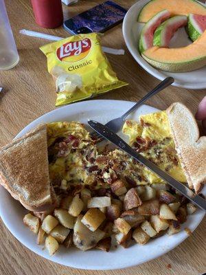 Bacon and egg omelette with toast and home fries‍