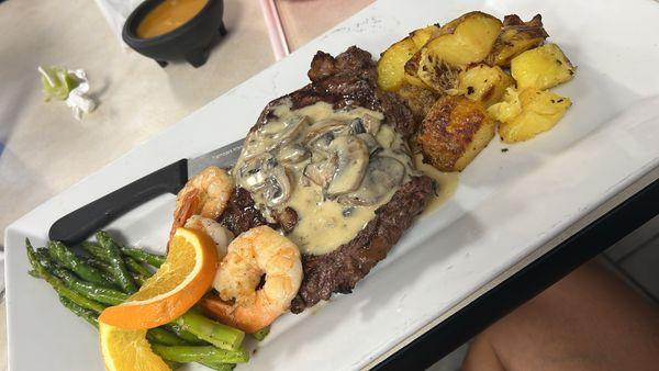 10oz ribeye with shrimp, potatoes and asparagus. Their mushroom sauce is to die for!