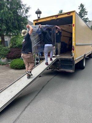 Carrying a carefully wrapped Table into truck