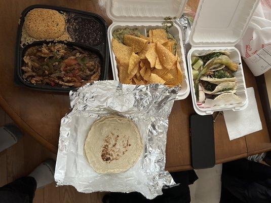 Fajitas, guac dip and tacos.