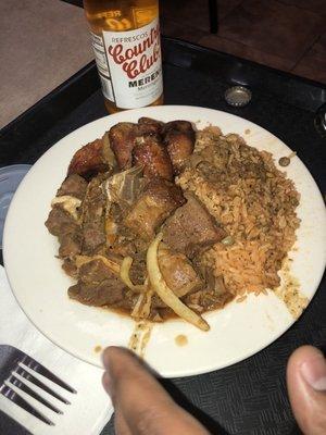 Moro de guandules (yellow rices with pigeon peas), chivo (roasted goat) and sweet platains.