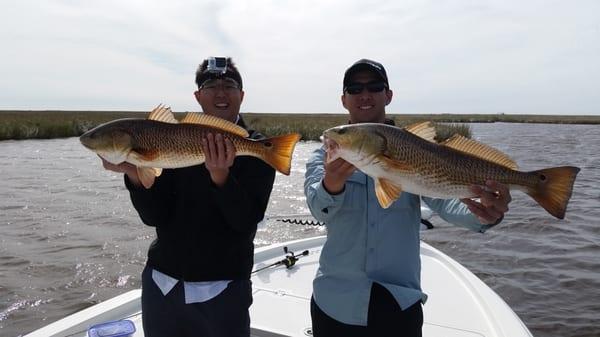 Double up on reds just 30 miles south east on downtown New Orleans on a Louisiana Fishing Trip.