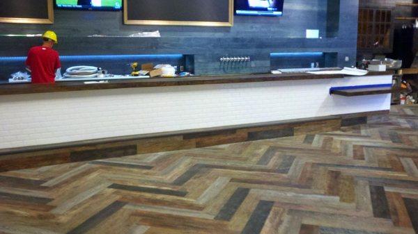 Herringbone LVT pattern installation at the Sea Hawks stadium.