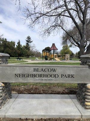 Signage and children's playground behind.