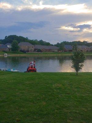 Two Broke Brothers mowing lake lot