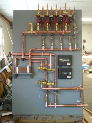 An overly tall distribution board to compensate for the plate to plate heat exchanger ready for install.