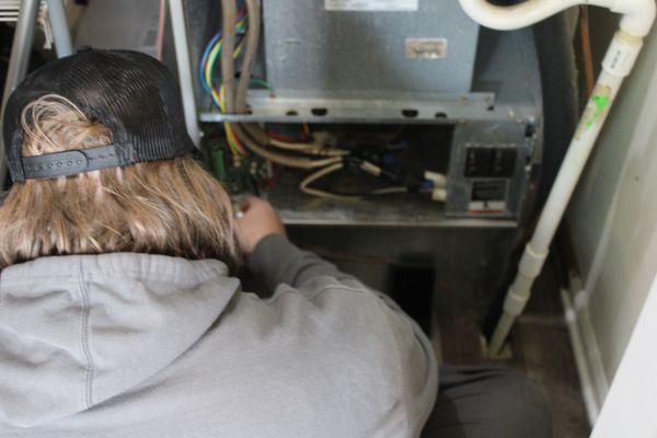 Tech working on HVAC furnace