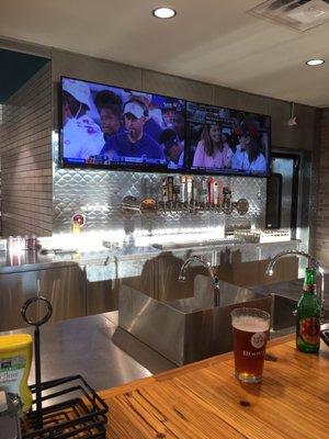 The craft beer taps and TVs at the bar