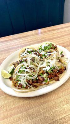 A plate of Alpastor tacos.