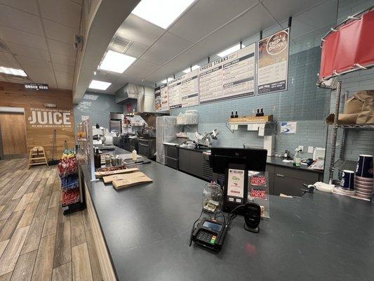 Empty Jersey Mikes with workers in the back taking personal calls.