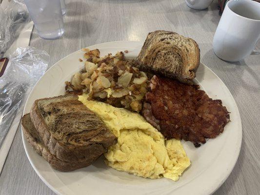 Scrambled eggs with corned beef home fries and rye toast