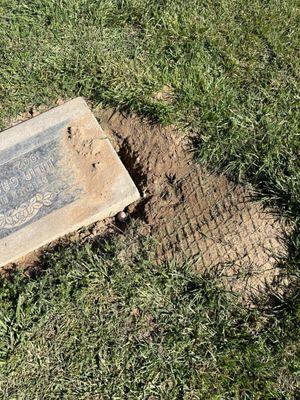 Hole and tracks on headstone