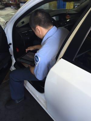 Michael working on my car while I wait.