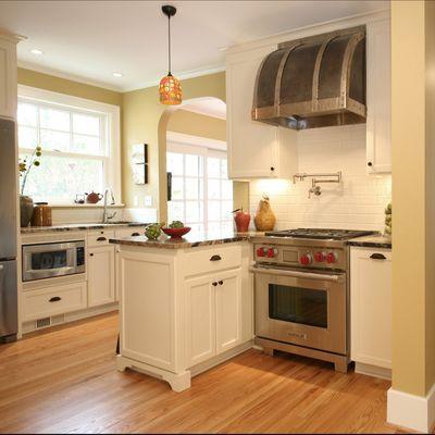 This Kitchen includes special appliances and finishes such as an industrial stove hood, pot filling station and antique stone countertops