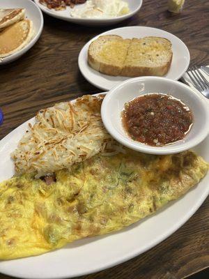 Denver omelette with fresh salsa, hash browns, and butter sourdough toast