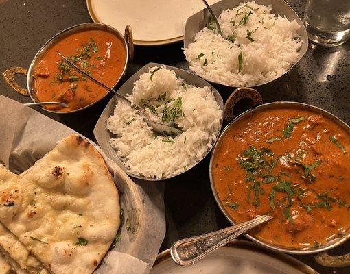 Chicken Tikka Masala (L), butter chicken (R), garlic naan and rice.