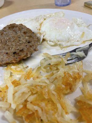 Three eggs, hashbrowns, sausage, and toast