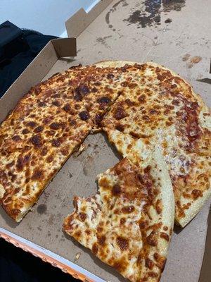 A pizza with a large bite taken from it