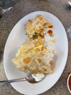 Southwest Breakfast burrito served with sour cream and salsa on the side