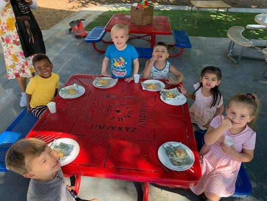 Children enjoy lunchtime in our lunch and play area.