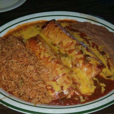 Chicken enchiladas with rice and refried beans.