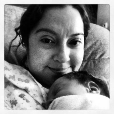 Me! Doula Meg holding one of my past clients baby boy at a postpartum visit.