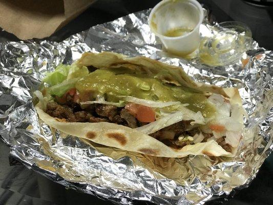 Beef fajita taco on flour with their delicious salsa verde!