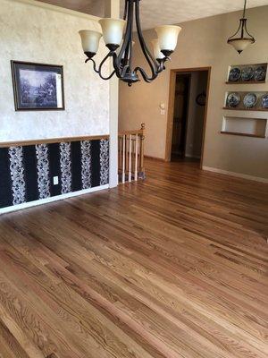 Another view of the old flooring(hallway and new flooring ding room).