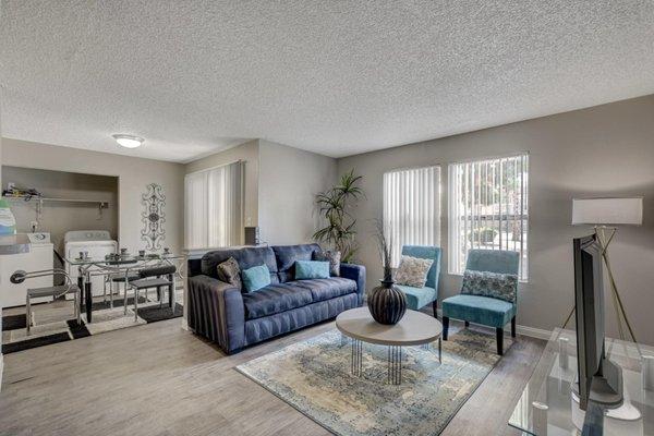 Spacious living room with sofa and two chairs