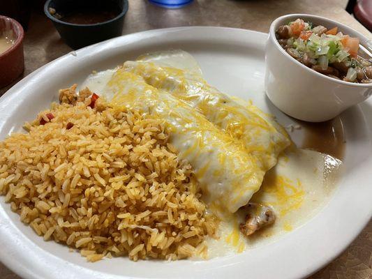 Fajita enchiladas with rice and Barracho beans. I filled my enchiladas with fajita chicken, smothered with sour cream sauce.