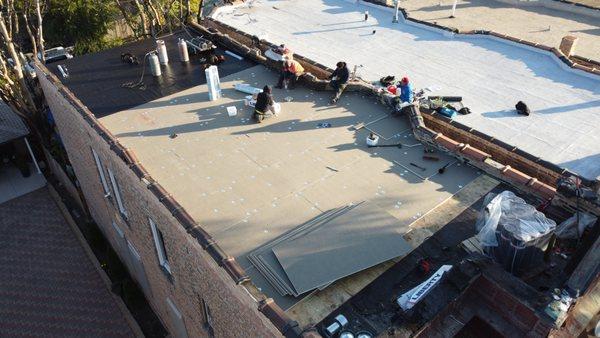 Here is a photo of roof insulation being secure into place and a liberty base self-adhering layer