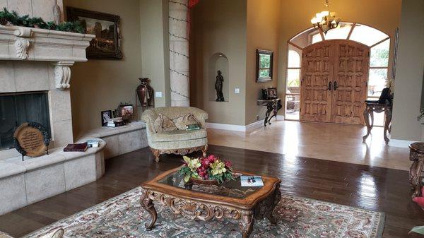 Precast fireplace, hardwood flooring, travertine, baseboard and precast columns and wrap around fireplace hearth.