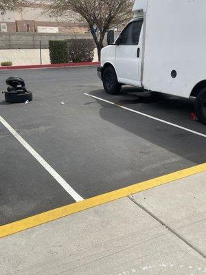 Looks like another old abandoned vehicle leaking fluid all over and old tires in the parking area