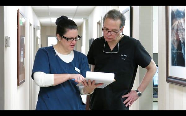 Dr. Robert Weiss consults with a medical assistant between treating patients at Maryland Laser Skin and Vein