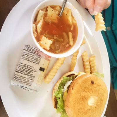 Regular cheeseburger and cup of vegetable soup