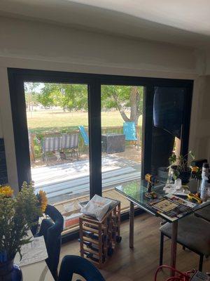 Our messy kitchen out to our messy deck. But the doors are beautiful!They do well with the 100 degree weather here too!