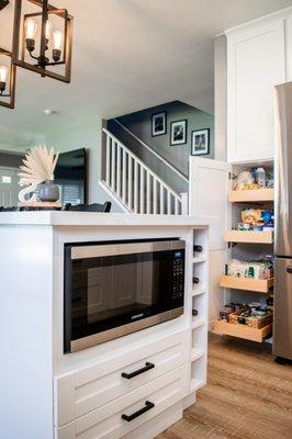 Custom cabinets. Inset microwave cabinet, wine rack, and pull out shelves