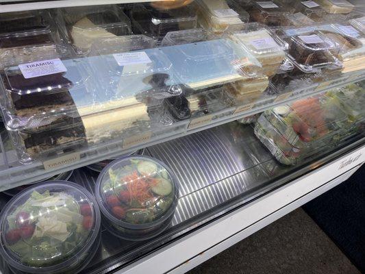 Case with desserts and salads